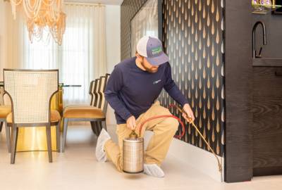 MaxPest-website-homepage-section-man-kneeling-spraying